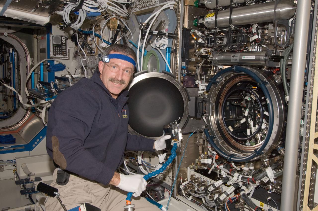ISS030-E-013378 (20 Dec. 2011) --- NASA astronaut Dan Burbank, Expedition 30 commander, works on the Combustion Integrated Rack (CIR) in the Destiny laboratory of the International Space Station.