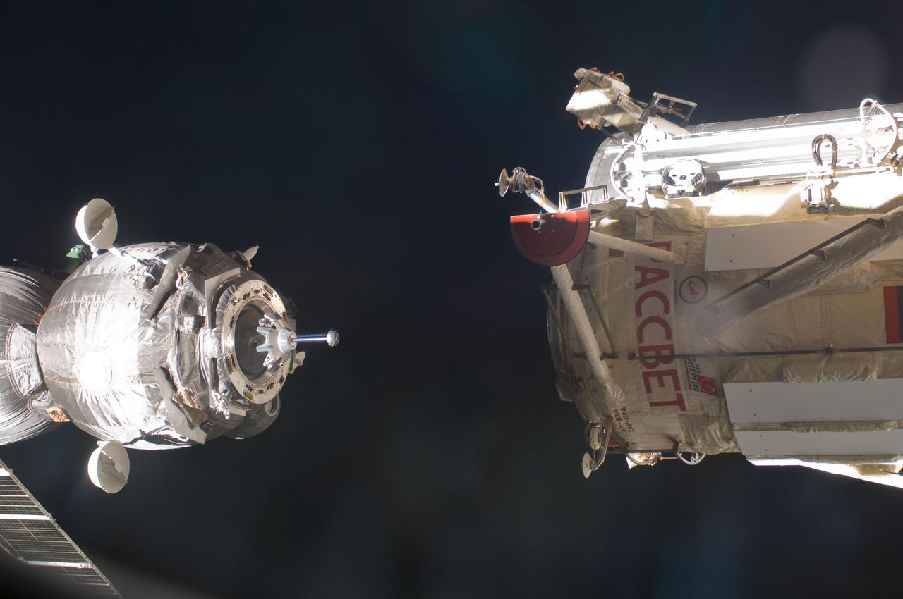 ISS030-E-015599 (23 Dec. 2011) --- With the  three Expedition 30/31 crew members aboard, the Soyuz TMA-03M spacecraft (left) eases toward its docking with the Russian-built Mini-Research Module 1 (MRM-1), also known as   Rassvet, Russian for "dawn."  The docking, which once more enables six astronauts and cosmonauts to work together aboard the   Earth-orbiting International Space Station, took place at 9:19 a.m. (CST) on Dec. 23, 2011.