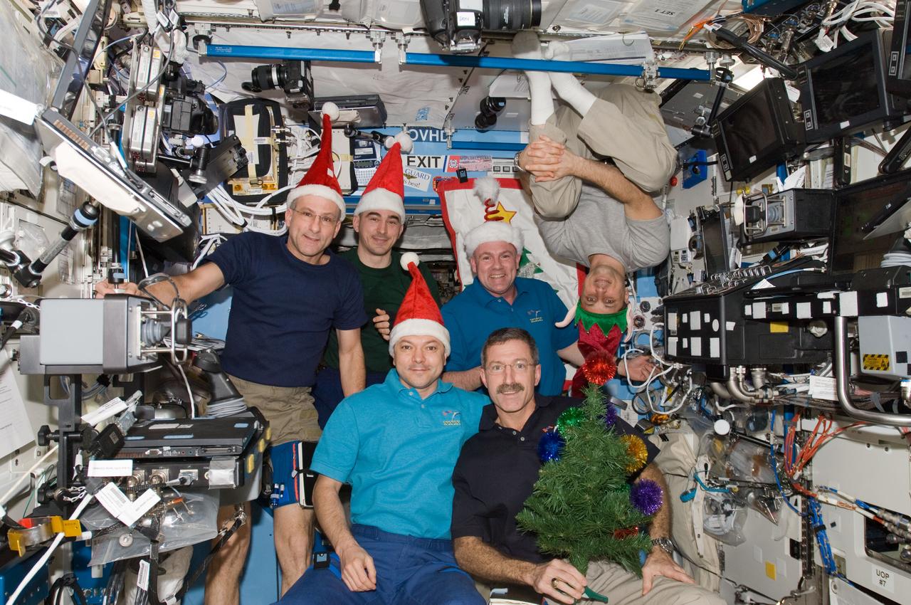 ISS030-E-015660 (25 Dec. 2011) --- The six Expedition 30 crew members assemble in the U.S. Lab (Destiny) aboard the International Space Station for a brief celebration of the Christmas holiday on Dec. 25. In front are Expedition 30 Commander Dan Burbank (right) and Flight Engineer Oleg Kononenko. On the back row, left to right, are Flight Engineers Don Pettit, Anatoly Ivanishin, Andre Kuipers and Anton Shkaplerov (suspended with his feet anchored above the group). Burbank and Pettit are NASA astronauts; Kononenko, Shkaplerov and Ivanishin are Russian cosmonauts; and Kuipers represents the European Space Agency.
