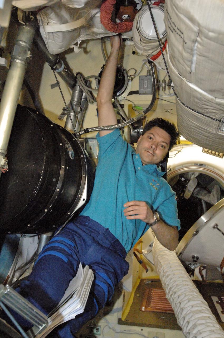 ISS030-E-016793 (28 Dec. 2011) --- Cosmonaut Oleg Kononenko, Expedition 30 flight engineer, installs and prepares equipment for a test run of a new science payload in the Mini Research Module 2 or Poisk aboard the International Space Station.