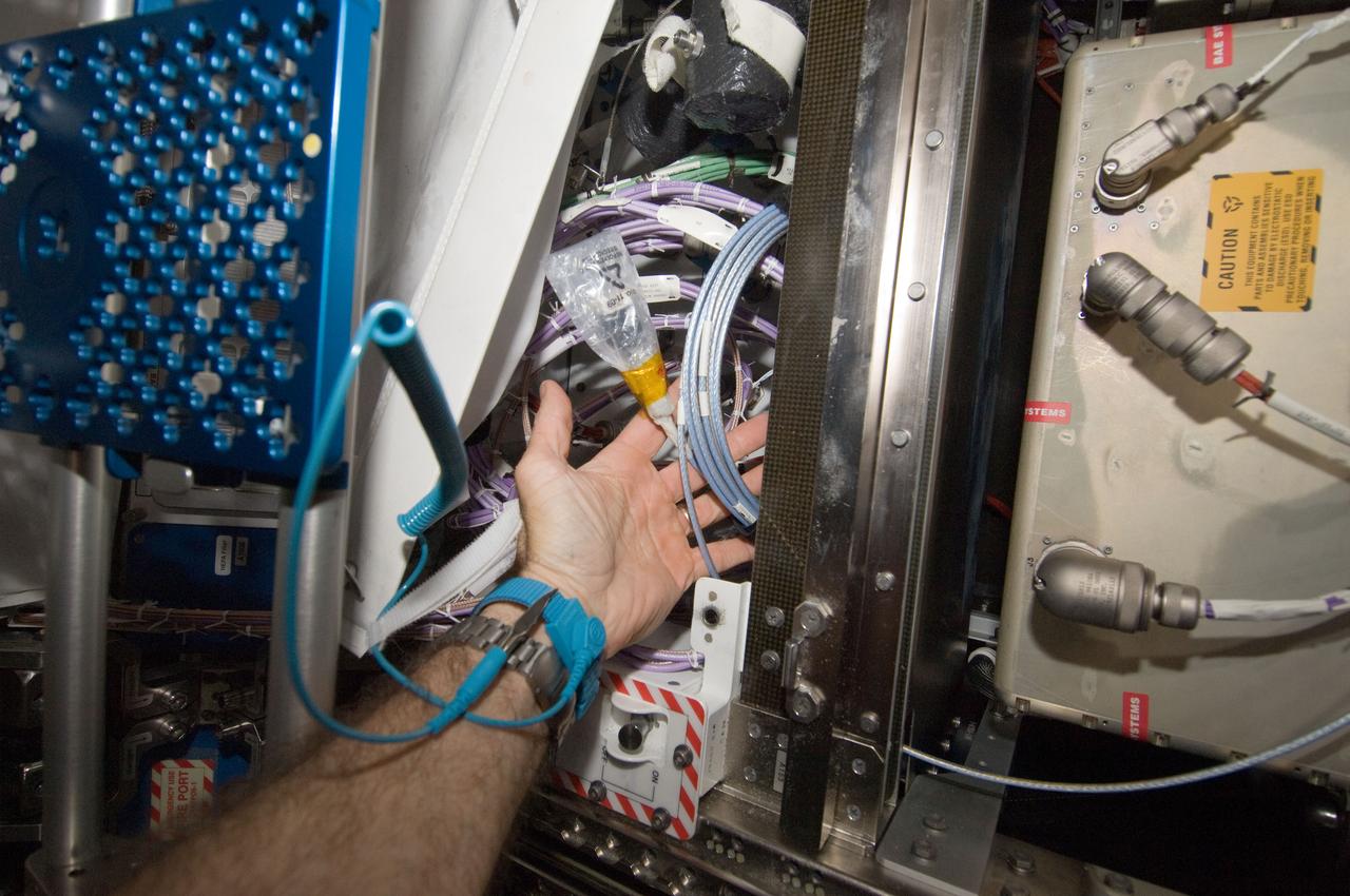 ISS030-E-017789 (29 Dec. 2011) --- Working in chorus with the International Space Station team in Houston?s Mission Control Center, this astronaut and his Expedition 30 crewmates on the station install a set of Enhanced Processor and Integrated Communications (EPIC) computer cards in one of seven primary computers onboard. The upgrade will allow more experiments to operate simultaneously, and prepare for the arrival of commercial cargo ships later this year.