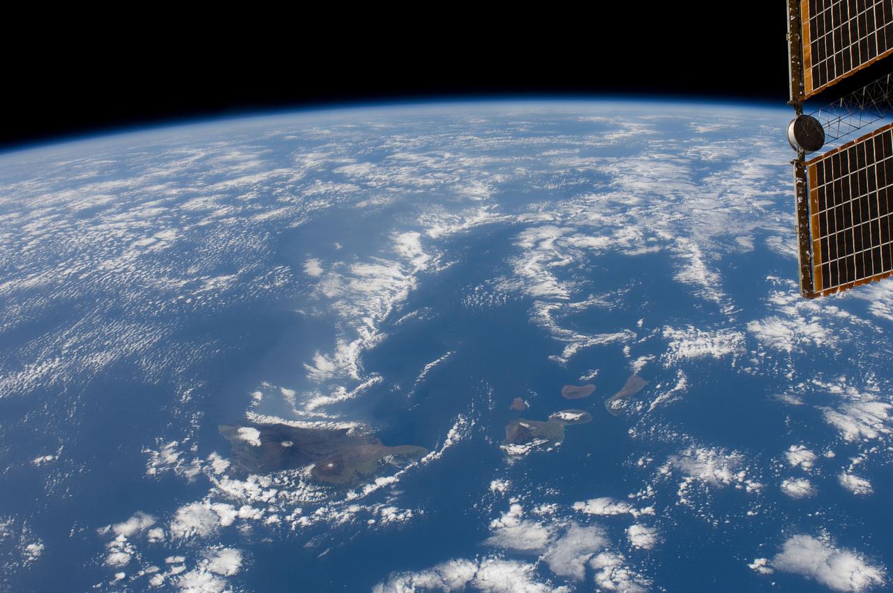 ISS030-E-019057 (29 Dec. 2011) --- One of the Expedition 30 crew members aboard the International Space Station captured this image of the Hawaiian Island chain on Dec. 29, 2011.  The Big Island of Hawaii is easily delineated at the center of the frame. The object in upper right is the edge of a solar panel.