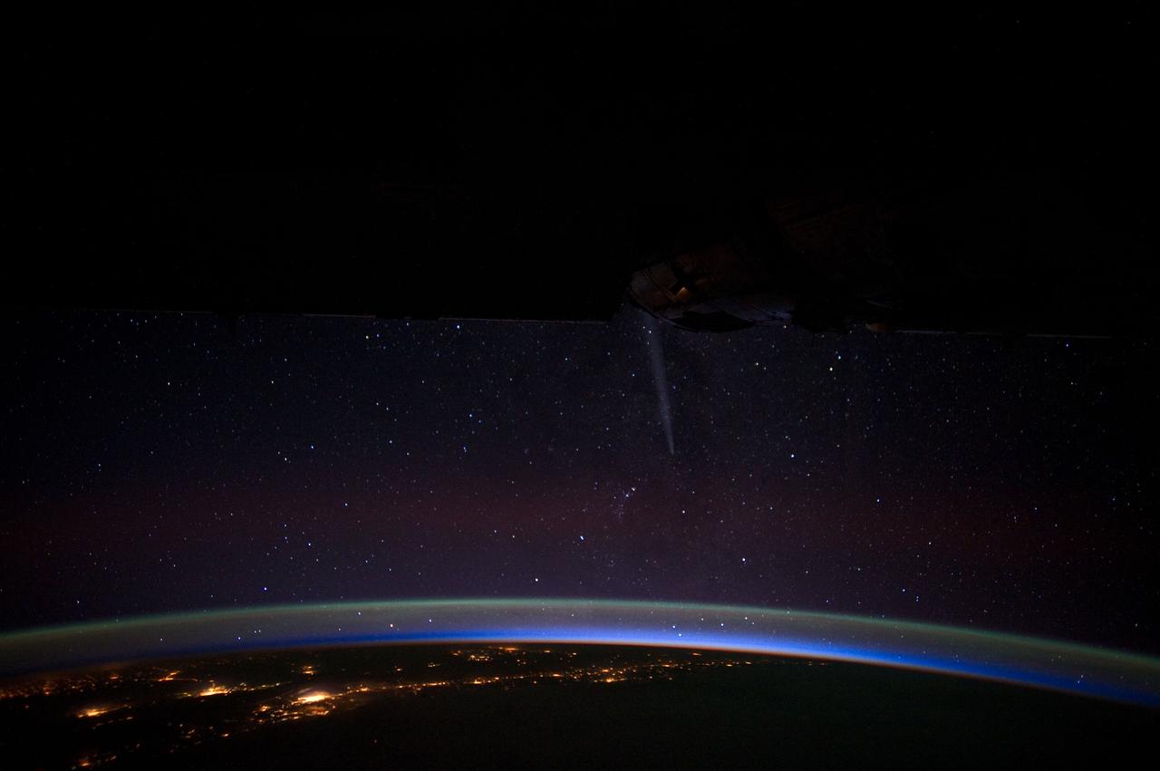 ISS030-E-020039 (26 Dec. 2011) --- This busy night time panorama was photographed by one of the Expedition 30 crew members from the International Space Station on Dec. 26, 2011. Comet Lovejoy streaks through the star-filled sky just to the right of center. The land mass is the coast of Chile, looking southeast, with several coastal cities in the capital city region near Santiago.  A 28-mm focal length was used to record the image.