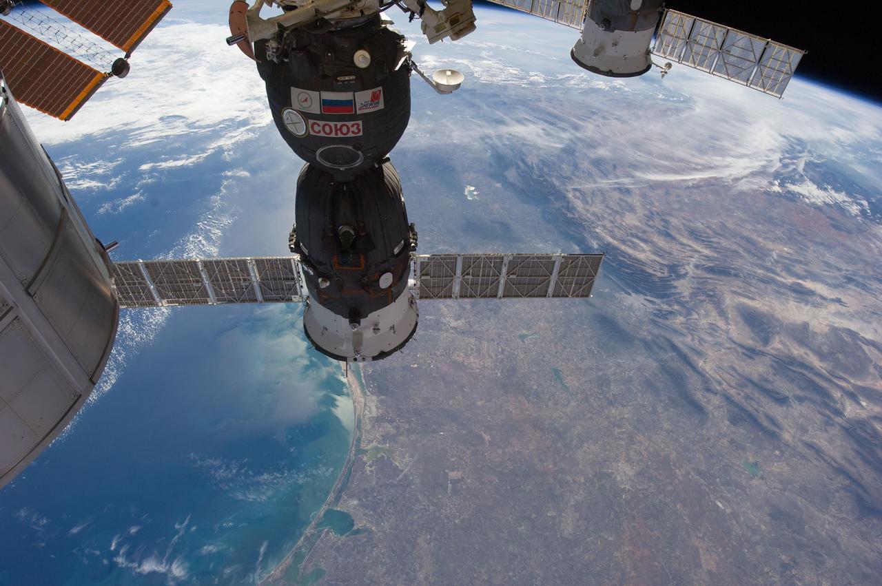 ISS030-E-020725 (29 Dec. 2011) --- With parts of two Russian spacecraft docked to the International Space Station in the foreground, this image from the orbital outpost shows the Gulf of Mexico and parts of Texas and Mexico. One of the Expedition 30 crew members took the photograph on Dec. 29, 2011. The two spacecraft are a Soyuz in the foreground, and a Progress, partially visible at top right.