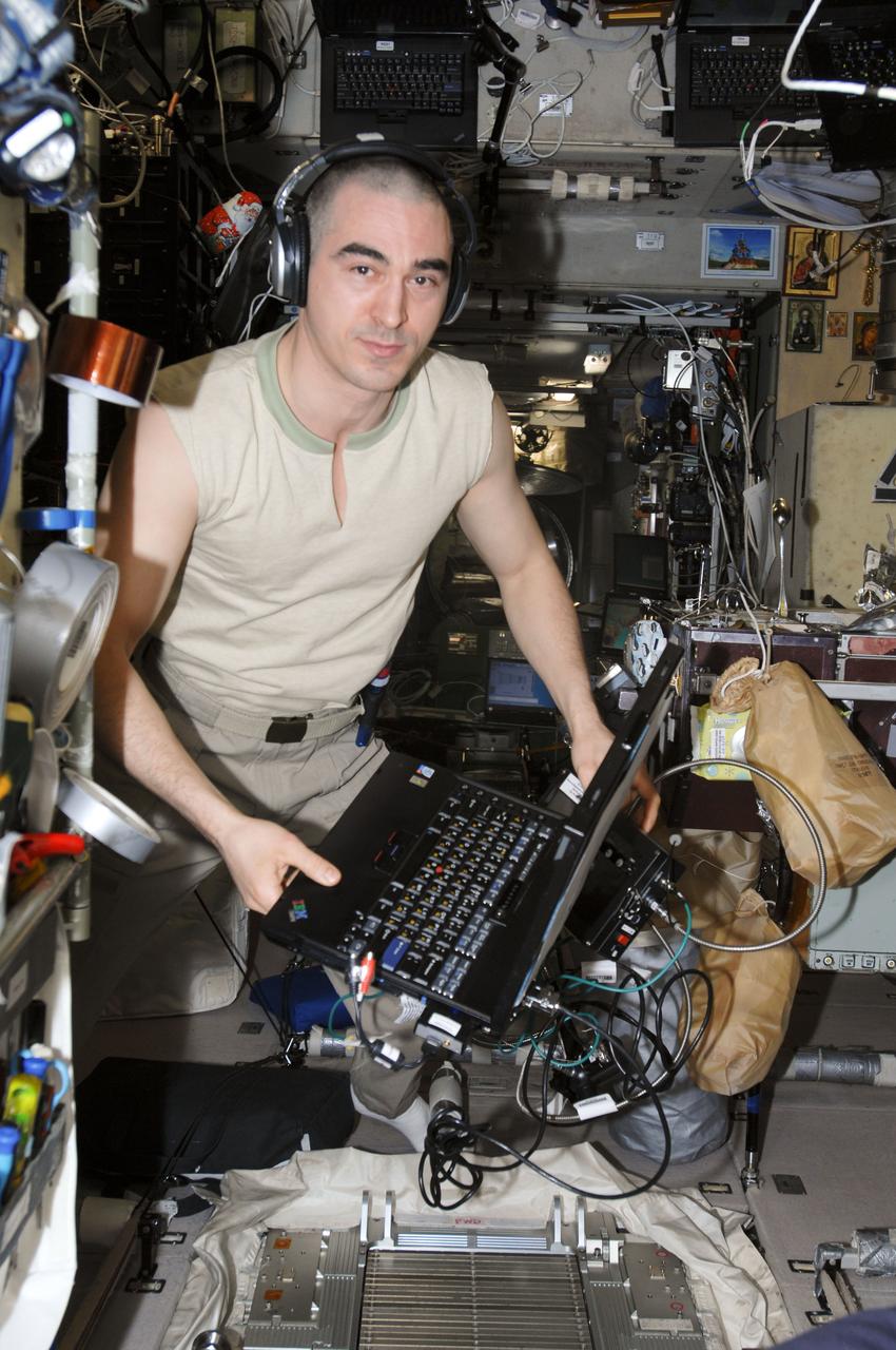 ISS030-E-021036 (5 Jan. 2012) --- Russian cosmonaut Anatoly Ivanishin, Expedition 30 flight engineer, wears a communication system headset while using a computer in the Zvezda Service Module of the International Space Station.