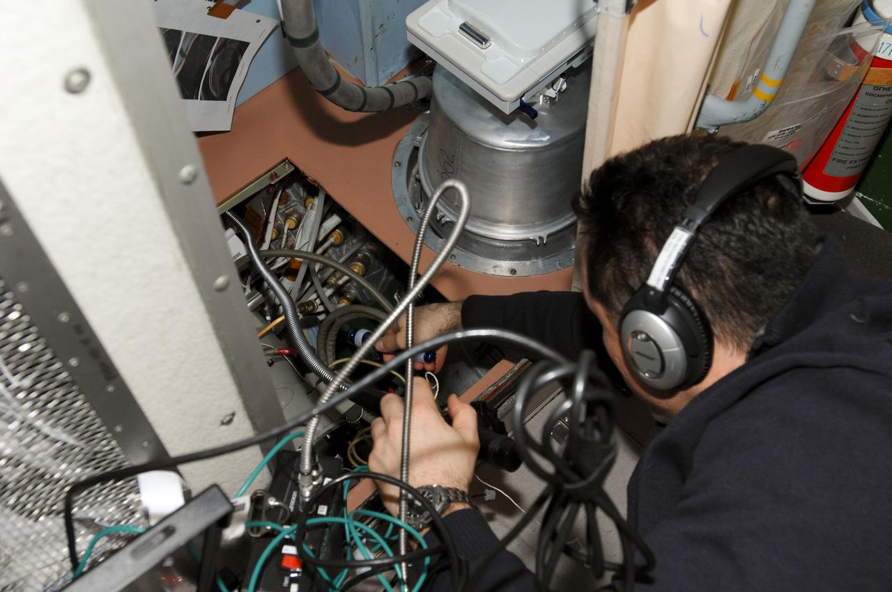 ISS030-E-021041 (5 Jan. 2012) --- Russian cosmonaut Anton Shkaplerov, Expedition 30 flight engineer, wears a communication system headset while working with a video display unit in the Zvezda Service Module of the International Space Station.
