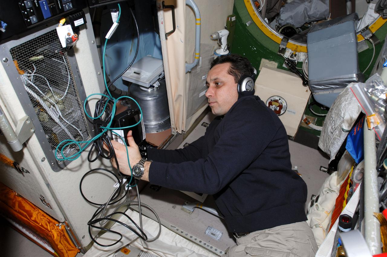 ISS030-E-021042 (5 Jan. 2012) --- Russian cosmonaut Anton Shkaplerov, Expedition 30 flight engineer, wears a communication system headset while working with a video display unit in the Zvezda Service Module of the International Space Station.