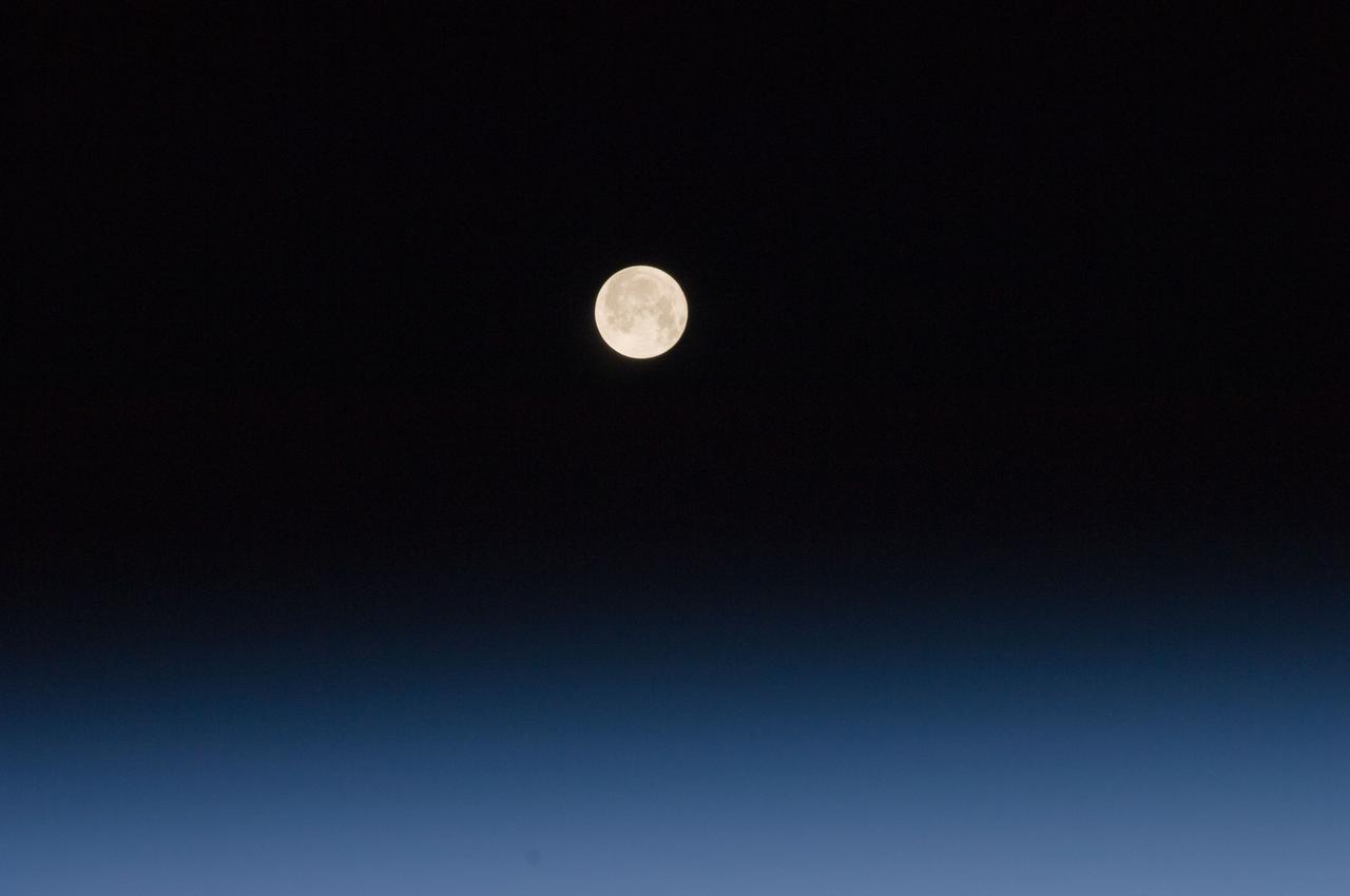 ISS030-E-028893 (9 Jan. 2012) --- One of a series of photos of the moon and Earth?s atmosphere as seen from the International Space Station over a period of time that covered a number of orbits by the orbital outpost.