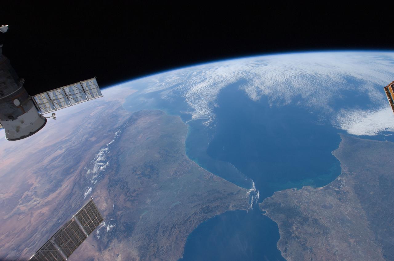 ISS030-E-030428 (31 Dec. 2011) --- This high oblique panorama shows Morocco and Spain as photographed by the Expedition 30 crew members aboard the International Space Station. The Atlantic Ocean, Straits of Gibraltar and Alboran Sea (the westernmost portion of the Mediterranean Sea) separate Spain on the right from Morocco on the left. Algeciras Harbor is the prominent notch cut out of the eastern end of the north shore of the Strait. A Russian spacecraft, docked to the orbital outpost, is in the upper left corner.