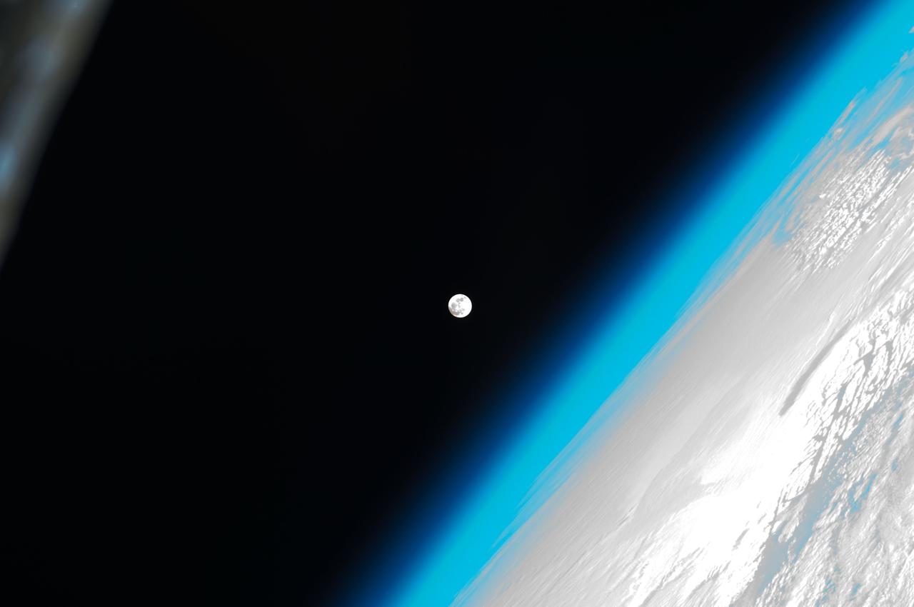ISS030-E-031275 (8 Jan. 2012) --- One of a series of photos of the moon and Earth's atmosphere as seen from the International Space Station over a period of time that covered a number of orbits by the orbital outpost.