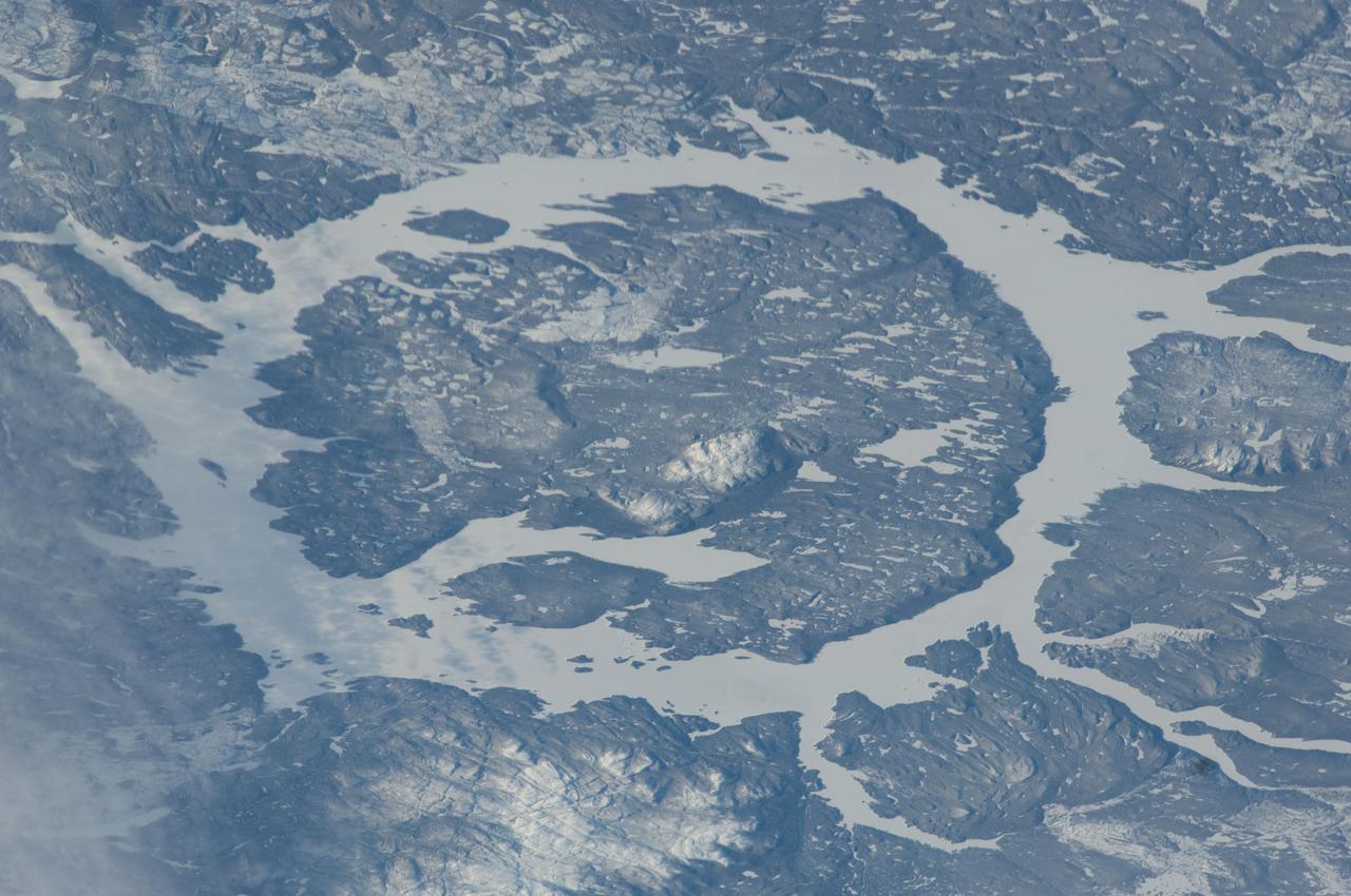 ISS030-E-031663 (8 Jan. 2012) --- This photo showing the Manicouagan Reservoir in Quebec, Canada, was photographed by one of the  Expedition 30 crew members aboard the International Space Station. The Manicouagan Reservoir marks the site of an impact crater, 60 miles (100 kilometers) wide, which, according to scientists, was formed 212 million years ago when a meteorite crashed into this area. Scientists say that over millions of years the many advancing and retreating glaciers and other erosional processes have worn down the crater.