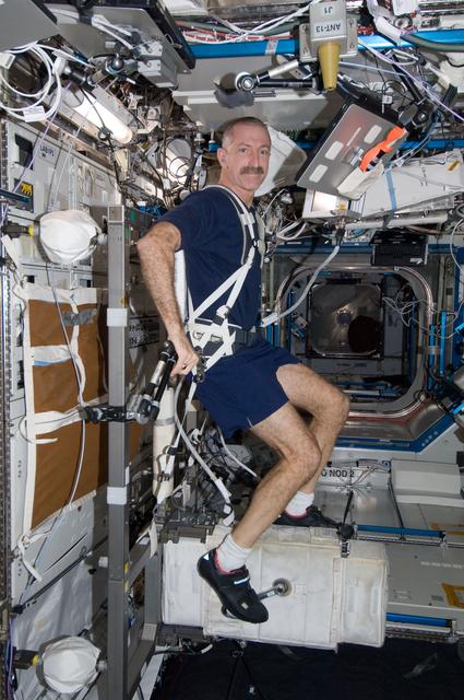 NASA image: Burbank exercises on the CEVIS in the U.S. Lab