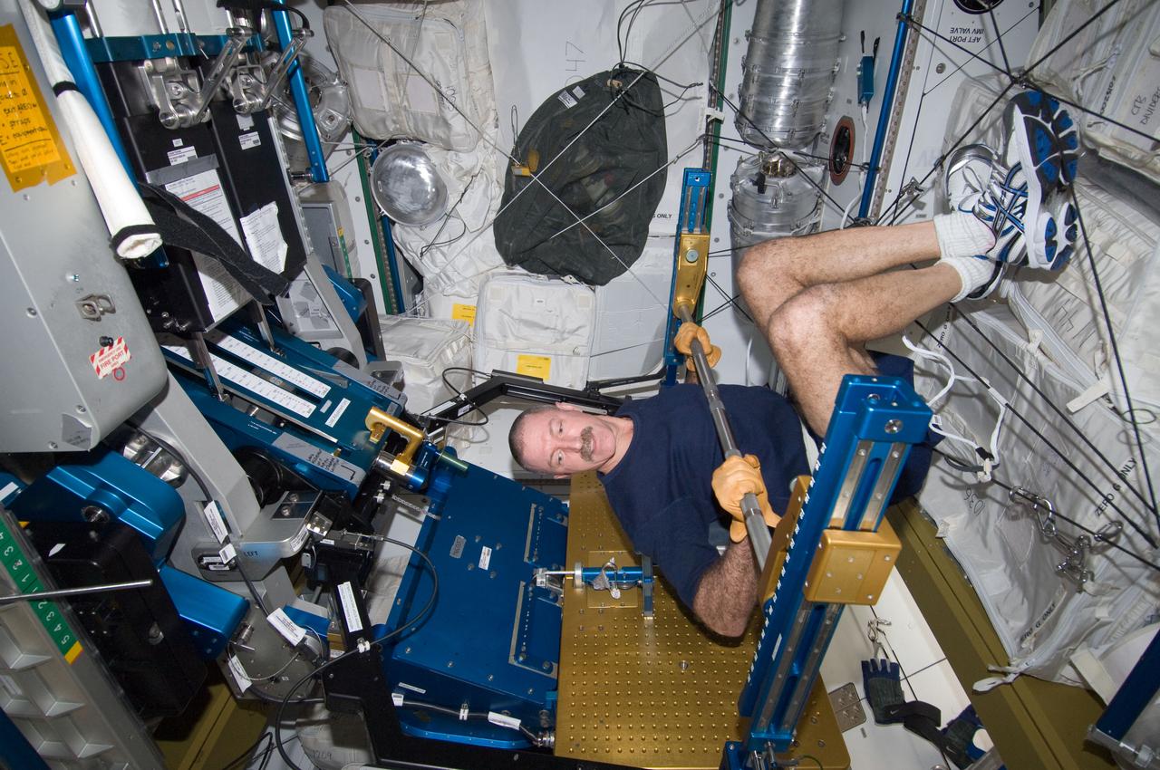 ISS030-E-033056 (9 Jan. 2012) --- NASA astronaut Dan Burbank, Expedition 30 flight commander, exercises, using the advanced Resistive Exercise Device (aRED) in the Tranquility node of the International Space Station.