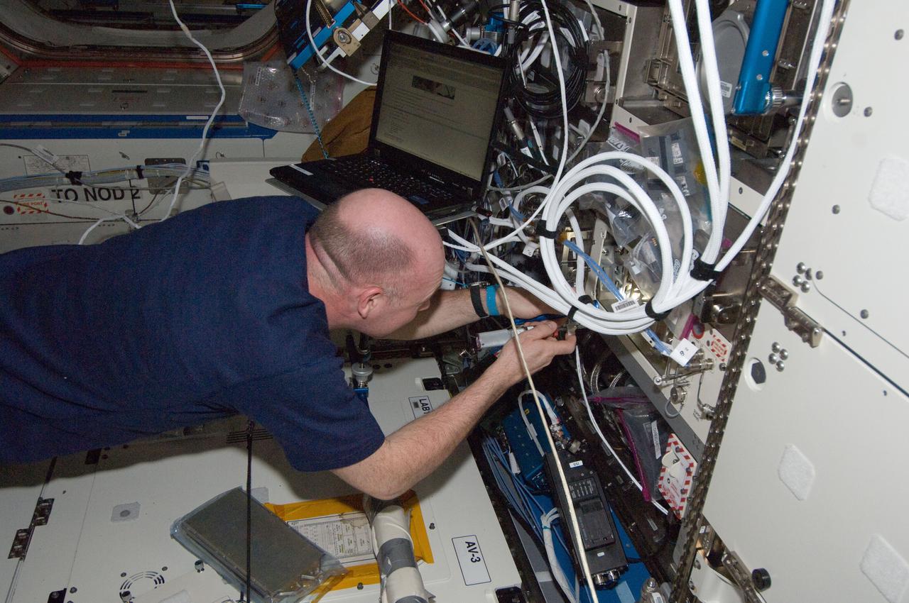 ISS030-E-033367 (28 Dec. 2011) --- In the International Space Station?s Destiny laboratory, European Space Agency astronaut Andre Kuipers, Expedition 30 flight engineer, replaces the faulty Exchangeable Standard Electronic Module 1 (ESEM-1) behind the front panel of the Microgravity Science Glovebox Remote Power Distribution Assembly (MSG RPDA) with the new spare.  The ESEM is used to distribute station main power to the entire MSG facility.