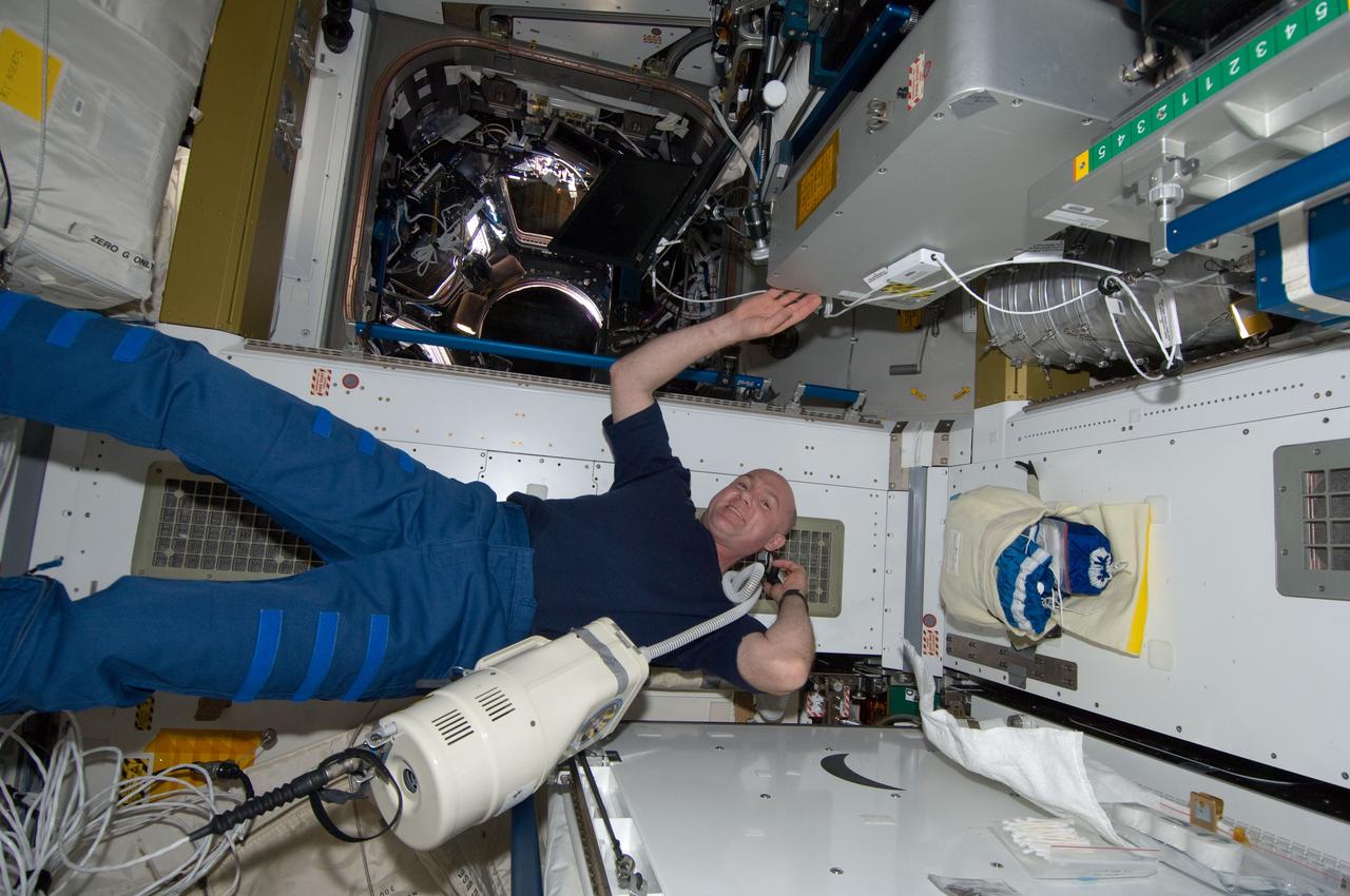 ISS030-E-033548 (30 Dec. 2011) --- European Space Agency astronaut Andre Kuipers, Expedition 30 flight engineer, trims his hair in the Tranquility node of the International Space Station. Kuipers used hair clippers fashioned with a vacuum device to garner freshly cut hair.
