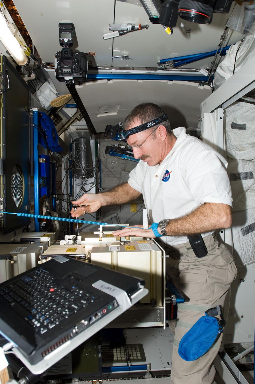 ISS030-E-047173 (23 Jan. 2012) --- NASA astronaut Dan Burbank, Expedition 30 commander, works with the Major Constituent Analyzer Mass Spectrometer Assembly (MCA MSA) of the Atmosphere Revitalization system in the Tranquility node of the International Space Station.