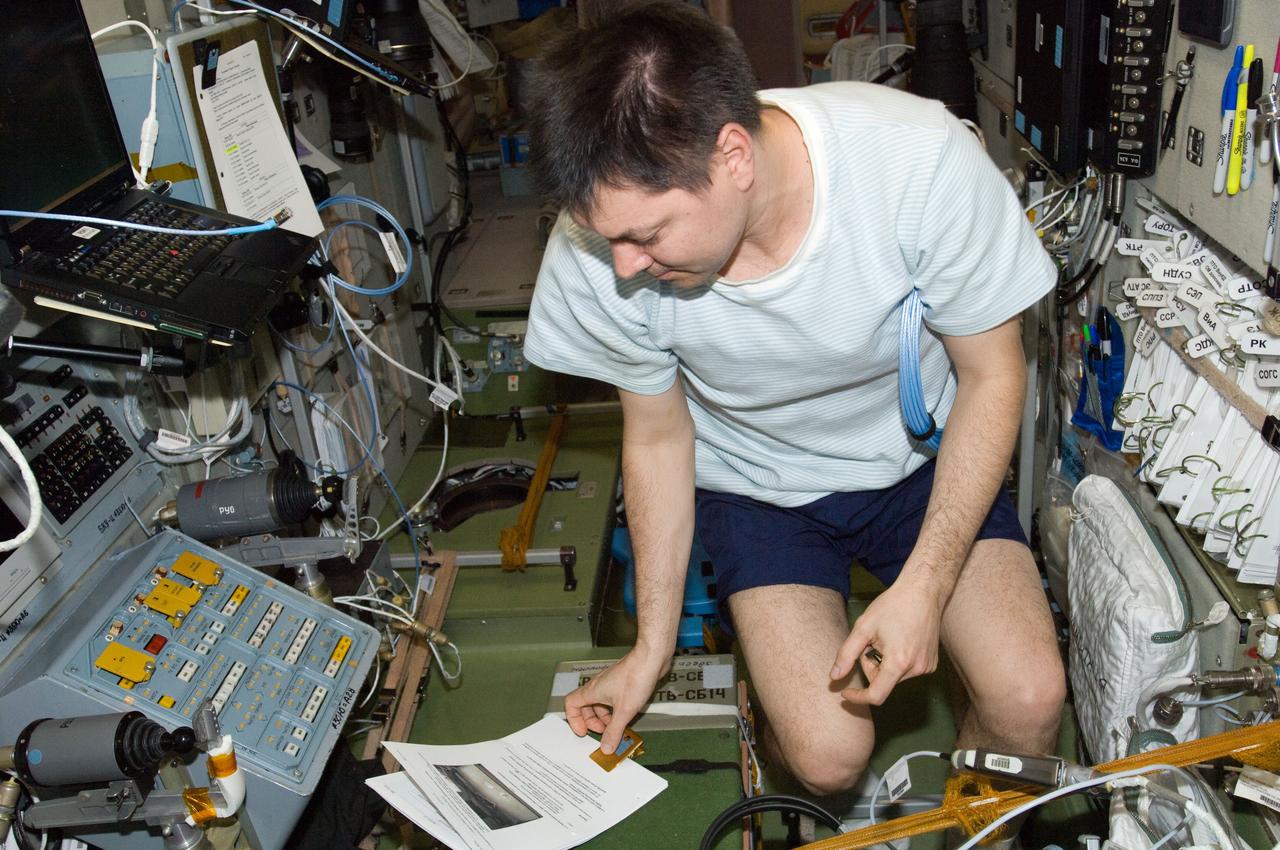 ISS030-E-047177 (23 Jan. 2012) --- Russian cosmonaut Oleg Kononenko, Expedition 30 flight engineer, reads a procedures checklist in the Zvezda Service Module of the International Space Station.