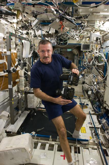 NASA image: Burbank works with two still cameras mounted together in the U.S. Laboratory