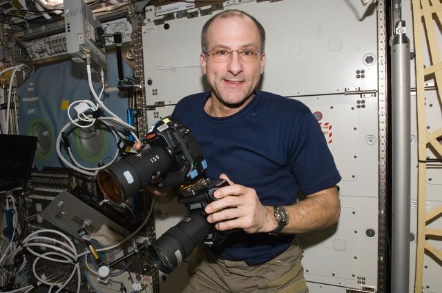 NASA image: Pettit works with two still cameras mounted together in the U.S. Laboratory