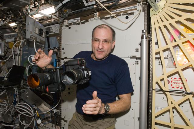 NASA image: Pettit works with two still cameras mounted together in the U.S. Laboratory