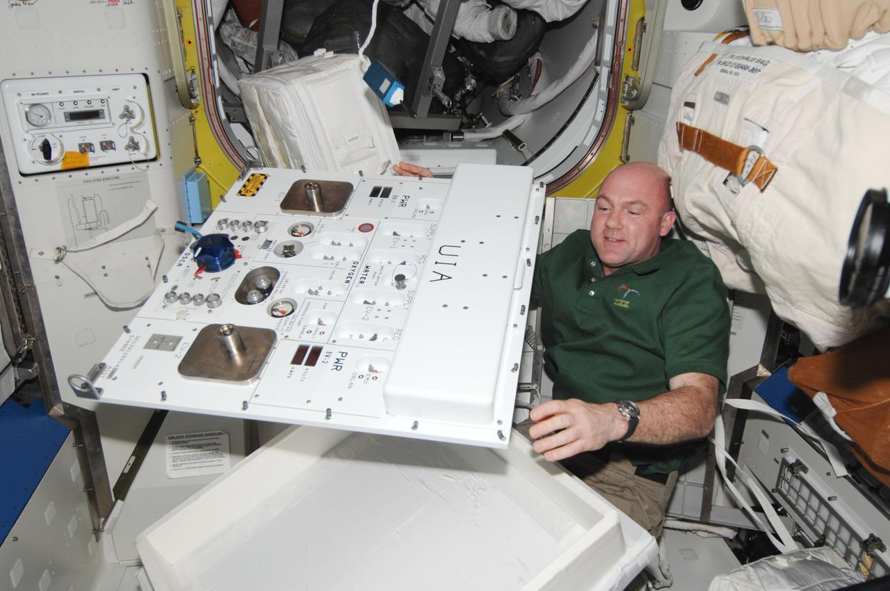 ISS030-E-050683 (27 Jan. 2012) --- European Space Agency astronaut Andre Kuipers, Expedition 30 flight engineer, works with Umbilical Interface Assembly (UIA) hardware in the Quest airlock of the International Space Station.