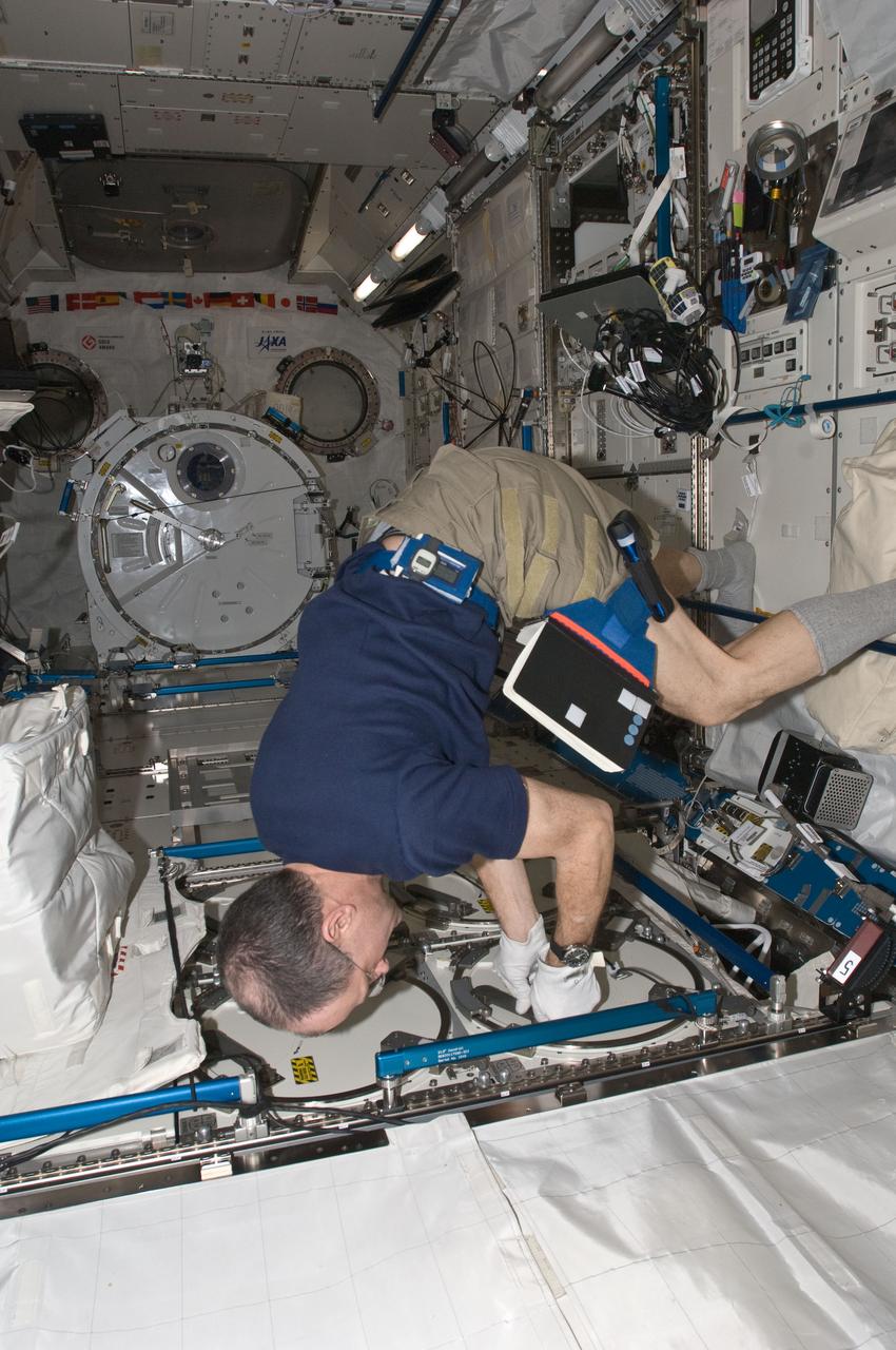 ISS030-E-050848 (26 Jan. 2012) --- NASA astronaut Don Pettit, Expedition 30 flight engineer, prepares to insert biological samples in the Minus Eighty Laboratory Freezer for ISS (MELFI-1) in the Kibo laboratory of the International Space Station.