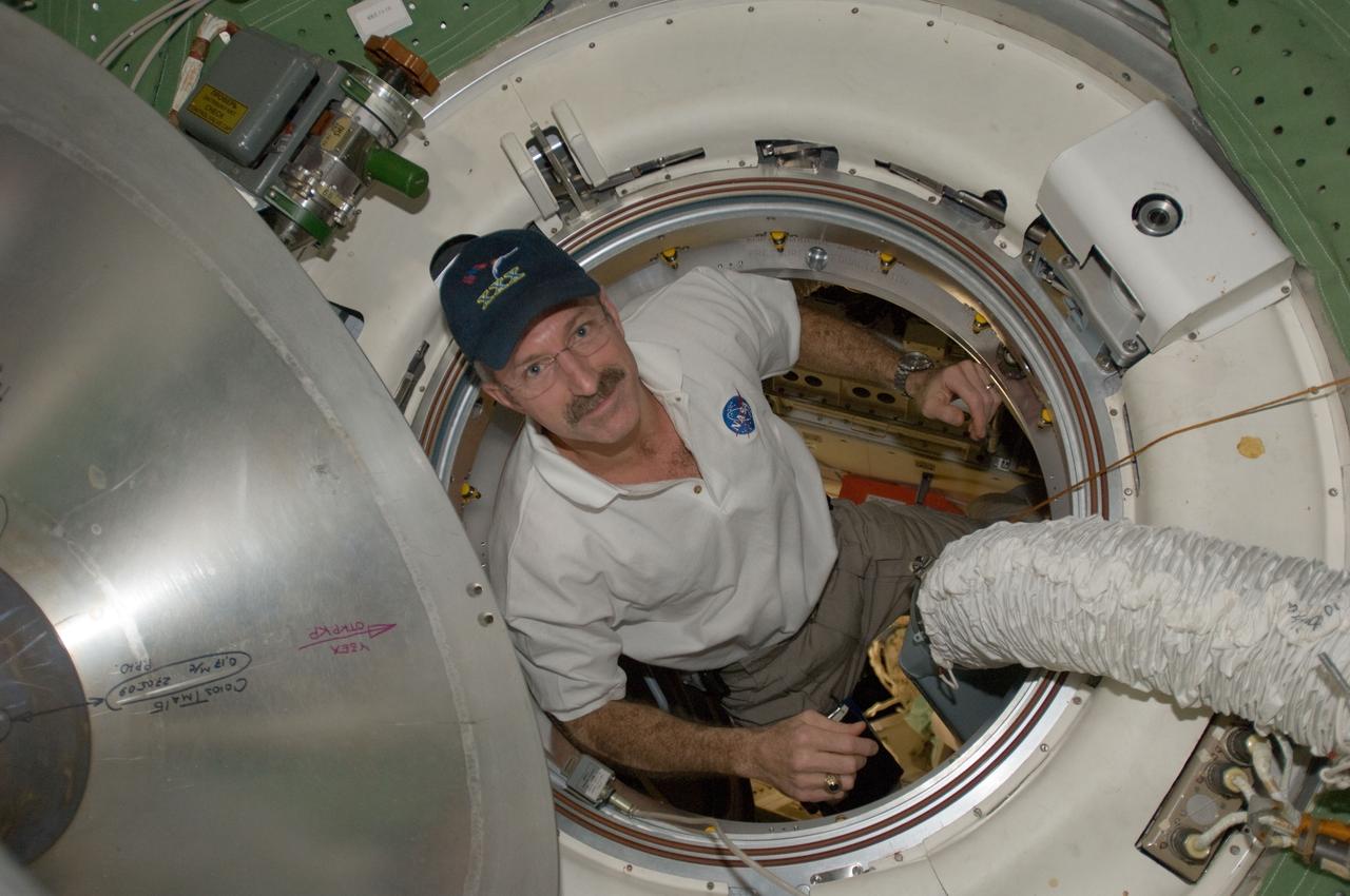 ISS030-E-050953 (27 Jan. 2012) --- NASA astronaut Dan Burbank, Expedition 30 commander, is pictured in a hatch as he exits the Rassvet Mini-Research Module 1 (MRM-1) into the Zarya Functional Cargo Block (FGB) transfer compartment of the International Space Station.