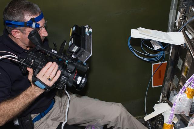 NASA image: Burbank uses video camera during installation and routing of HRCS Video Cables