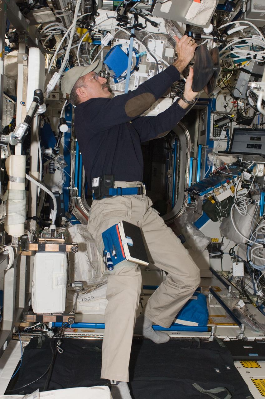 ISS030-E-060136 (2 Feb. 2012) --- NASA astronaut Dan Burbank, Expedition 30 commander, works with the Portable Pulmonary Function System (PPFS) Mixing Bag System (MBS) in the Destiny laboratory of the International Space Station.