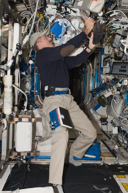 NASA image: Burbank works with the PPFS MBS in the U.S. Laboratory