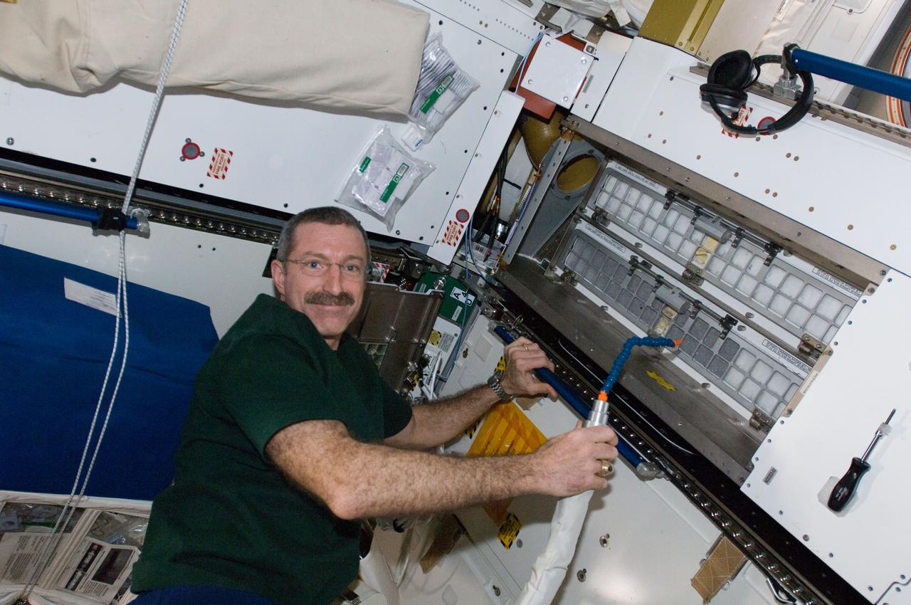 ISS030-E-060469 (4 Feb. 2012) --- NASA astronaut Dan Burbank, Expedition 30 commander, cleans cabin air bacteria filters in the Tranquility node of the International Space Station.