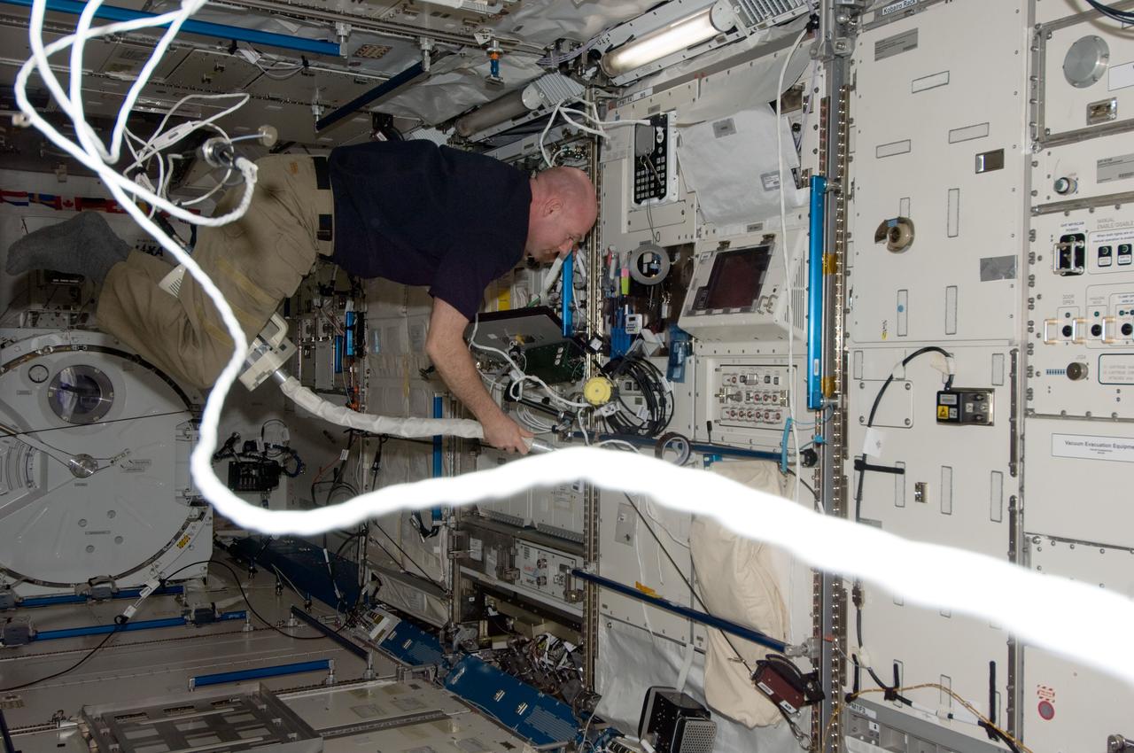 ISS030-E-065369 (15 Jan. 2012) --- European Space Agency astronaut Andre Kuipers, Expedition 30 flight engineer, uses a vacuum cleaner during housekeeping operations in the Kibo laboratory of the International Space Station.