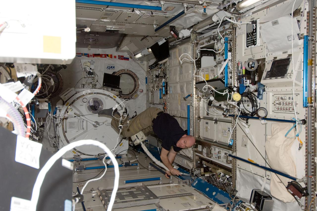 ISS030-E-065378 (15 Jan. 2012) --- European Space Agency astronaut Andre Kuipers, Expedition 30 flight engineer, uses a vacuum cleaner during housekeeping operations in the Kibo laboratory of the International Space Station.