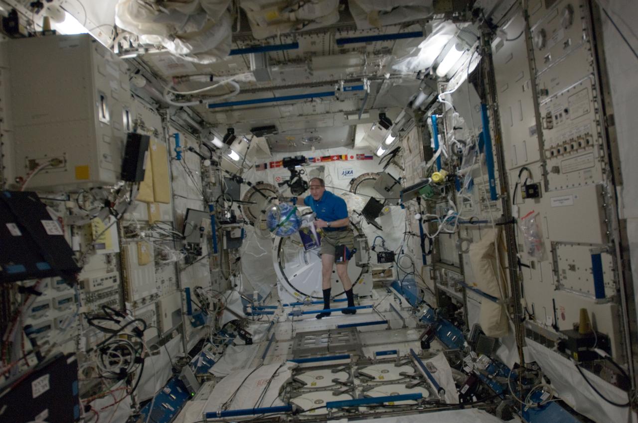 ISS030-E-074051 (14 Feb. 2012) --- NASA astronaut Don Pettit, Expedition 30 flight engineer, prepares for a NASA Education Payload Operations (EPO) activity in the Kibo laboratory of the International Space Station. Pettit is working with a soft Earth ball and an eraser tied to dental floss to demonstrate the space station orbiting Earth.