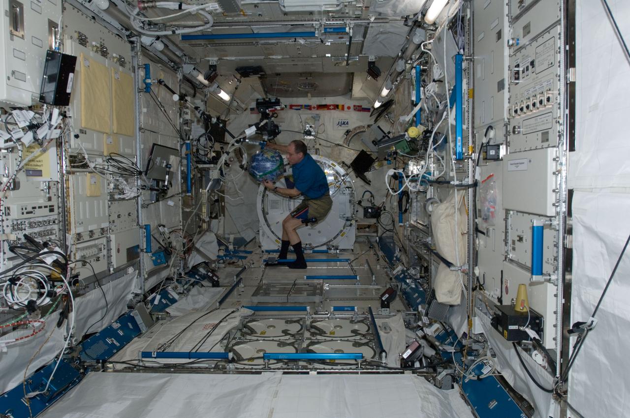 ISS030-E-074053 (14 Feb. 2012) --- NASA astronaut Don Pettit, Expedition 30 flight engineer, prepares for a NASA Education Payload Operations (EPO) activity in the Kibo laboratory of the International Space Station. Pettit is working with a soft Earth ball and an eraser tied to dental floss to demonstrate the space station orbiting Earth.