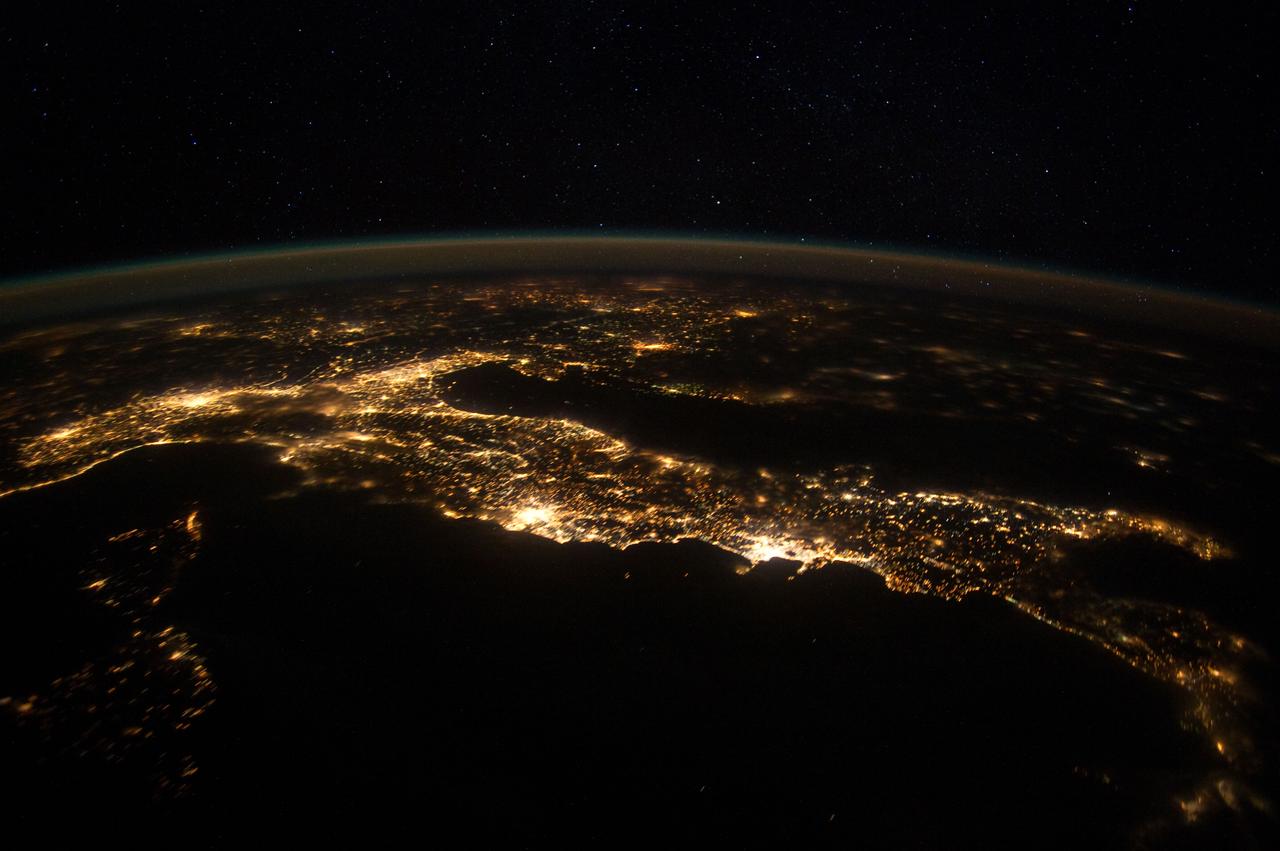 ISS030-E-074777 (25 Jan. 2012 ) --- This nighttime panorama of much of Europe was photographed by one of the Expedition 30 crew members aboard the International Space Station flying approximately 240 miles above the Tyrrhenian Sea on Jan. 25,  2012. Most of the country of Italy is visible running horizontally across the center of the frame, with the night lights of Rome and Naples being visible to the left and right of center, respectively.  Sardinia, and Corsica  are in the lower left quadrant of the photo. The Adriatic Sea is on the other side of Italy, and beyond it to the east and north can be seen parts of several other European nations.