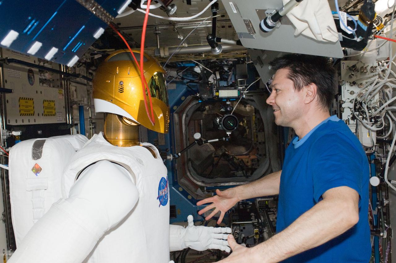 ISS030-E-075409 (15 Feb. 2012) --- Russian cosmonaut Oleg Kononenko, Expedition 30 flight engineer, and Robonaut 2 are pictured in the Destiny laboratory of the International Space Station.