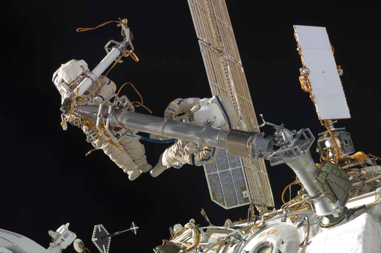 ISS030-E-078381 (16 Feb. 2012) --- Russian cosmonauts Oleg Kononenko and Anton Shkaplerov, both Expedition 30 flight engineers, participate in a session of extravehicular activity (EVA) to continue outfitting the International Space Station. During the six-hour, 15-minute spacewalk, Kononenko and Shkaplerov moved the Strela-1 crane from the Pirs Docking Compartment to begin preparing the Pirs for its replacement next year with a new laboratory and docking module. The duo used another boom, the Strela-2, to move the hand-operated crane to the Poisk module for future assembly and maintenance work. Both telescoping booms extend like fishing rods and are used to move massive components outside the station. On the exterior of the Poisk Mini-Research Module 2 (MRM2), they also installed the Vinoslivost Materials Sample Experiment, which will investigate the influence of space on the mechanical properties of the materials. The spacewalkers also collected a test sample from underneath the insulation on the Zvezda Service Module to search for any signs of living organisms. Both spacewalkers wore Russian Orlan spacesuits bearing blue stripes and equipped with NASA helmet cameras.