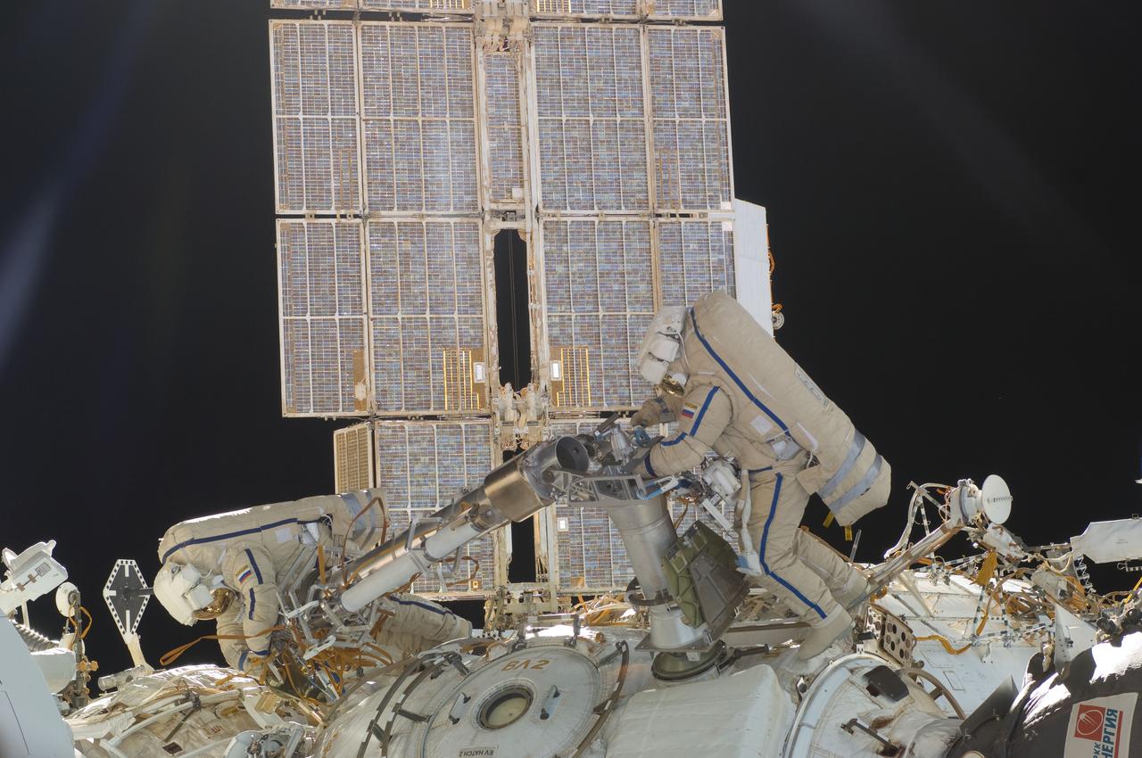 ISS030-E-078388 (16 Feb. 2012) --- Russian cosmonauts Oleg Kononenko and Anton Shkaplerov, both Expedition 30 flight engineers, participate in a session of extravehicular activity (EVA) to continue outfitting the International Space Station. During the six-hour, 15-minute spacewalk, Kononenko and Shkaplerov moved the Strela-1 crane from the Pirs Docking Compartment to begin preparing the Pirs for its replacement next year with a new laboratory and docking module. The duo used another boom, the Strela-2, to move the hand-operated crane to the Poisk module for future assembly and maintenance work. Both telescoping booms extend like fishing rods and are used to move massive components outside the station. On the exterior of the Poisk Mini-Research Module 2 (MRM2), they also installed the Vinoslivost Materials Sample Experiment, which will investigate the influence of space on the mechanical properties of the materials. The spacewalkers also collected a test sample from underneath the insulation on the Zvezda Service Module to search for any signs of living organisms. Both spacewalkers wore Russian Orlan spacesuits bearing blue stripes and equipped with NASA helmet cameras.