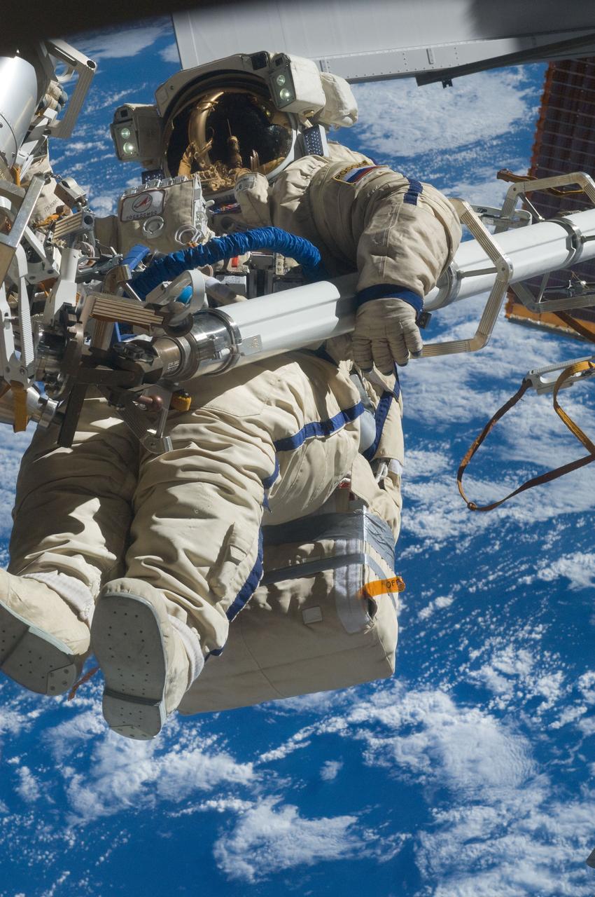 ISS030-E-079937 (16 Feb. 2012) --- Russian cosmonaut Anton Shkaplerov, Expedition 30 flight engineer, participates in a session of extravehicular activity (EVA) to continue outfitting the International Space Station. During the six-hour, 15-minute spacewalk, Shkaplerov and Russian cosmonaut Oleg Kononenko (out of frame), flight engineer, moved the Strela-1 crane from the Pirs Docking Compartment to begin preparing the Pirs for its replacement next year with a new laboratory and docking module. The duo used another boom, the Strela-2, to move the hand-operated crane to the Poisk module for future assembly and maintenance work. Both telescoping booms extend like fishing rods and are used to move massive components outside the station. On the exterior of the Poisk Mini-Research Module 2 (MRM2), they also installed the Vinoslivost Materials Sample Experiment, which will investigate the influence of space on the mechanical properties of the materials. The spacewalkers also collected a test sample from underneath the insulation on the Zvezda Service Module to search for any signs of living organisms. Both spacewalkers wore Russian Orlan spacesuits bearing blue stripes and equipped with NASA helmet cameras.