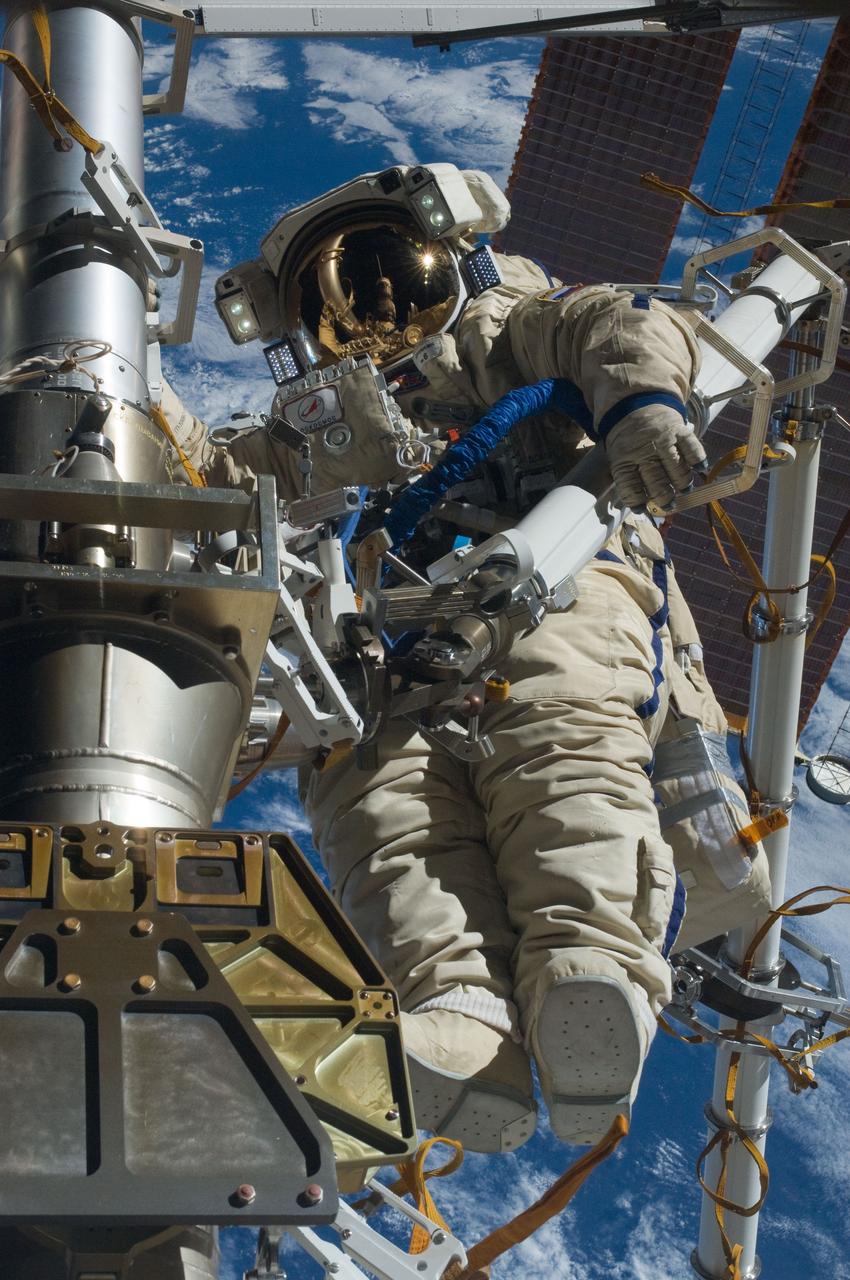 ISS030-E-079943 (16 Feb. 2012) --- Russian cosmonaut Anton Shkaplerov, Expedition 30 flight engineer, participates in a session of extravehicular activity (EVA) to continue outfitting the International Space Station. During the six-hour, 15-minute spacewalk, Shkaplerov and Russian cosmonaut Oleg Kononenko (out of frame), flight engineer, moved the Strela-1 crane from the Pirs Docking Compartment to begin preparing the Pirs for its replacement next year with a new laboratory and docking module. The duo used another boom, the Strela-2, to move the hand-operated crane to the Poisk module for future assembly and maintenance work. Both telescoping booms extend like fishing rods and are used to move massive components outside the station. On the exterior of the Poisk Mini-Research Module 2 (MRM2), they also installed the Vinoslivost Materials Sample Experiment, which will investigate the influence of space on the mechanical properties of the materials. The spacewalkers also collected a test sample from underneath the insulation on the Zvezda Service Module to search for any signs of living organisms. Both spacewalkers wore Russian Orlan spacesuits bearing blue stripes and equipped with NASA helmet cameras.