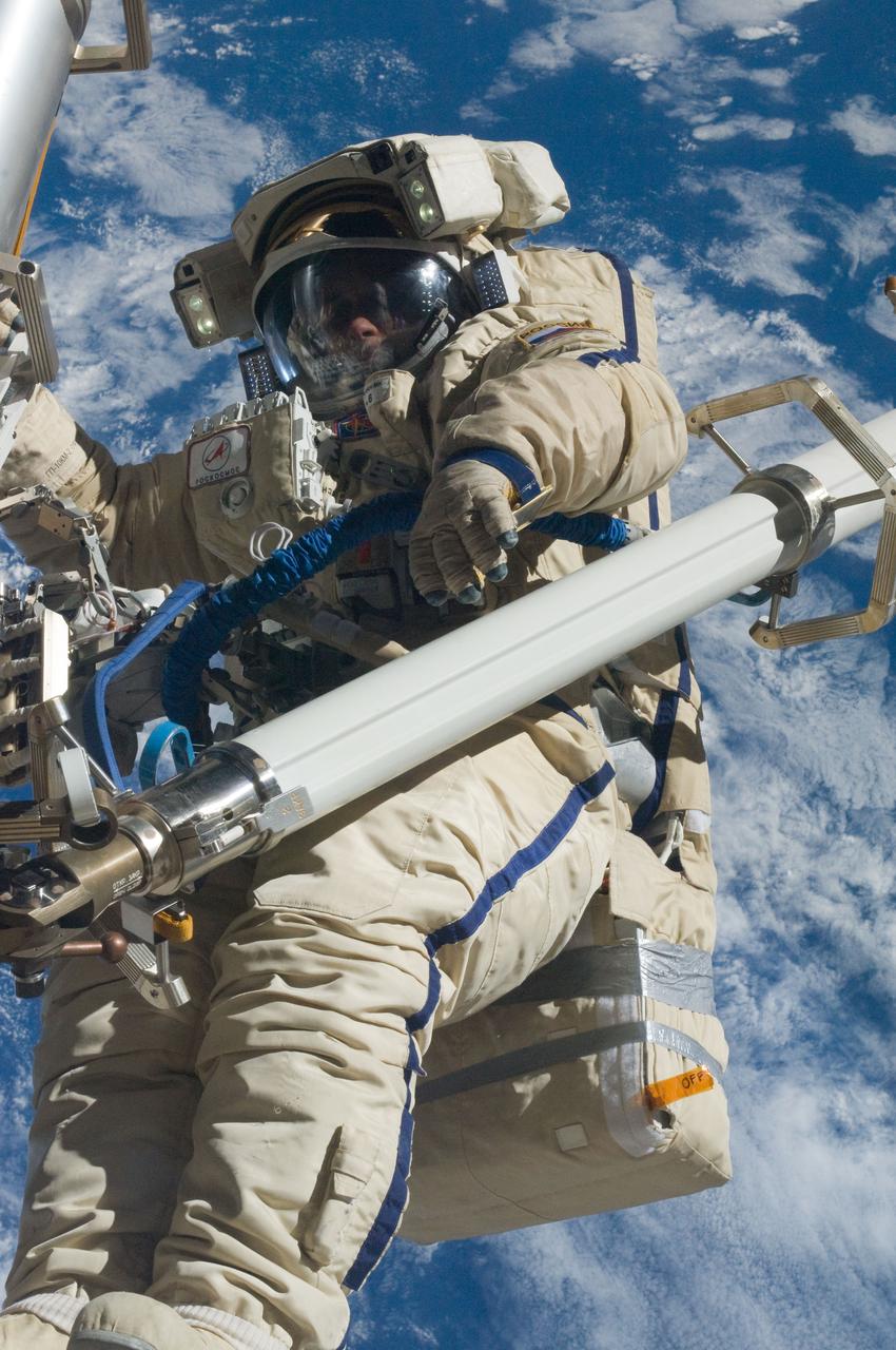 ISS030-E-079949 (16 Feb. 2012) --- Russian cosmonaut Anton Shkaplerov, Expedition 30 flight engineer, participates in a session of extravehicular activity (EVA) to continue outfitting the International Space Station. During the six-hour, 15-minute spacewalk, Shkaplerov and Russian cosmonaut Oleg Kononenko (out of frame), flight engineer, moved the Strela-1 crane from the Pirs Docking Compartment to begin preparing the Pirs for its replacement next year with a new laboratory and docking module. The duo used another boom, the Strela-2, to move the hand-operated crane to the Poisk module for future assembly and maintenance work. Both telescoping booms extend like fishing rods and are used to move massive components outside the station. On the exterior of the Poisk Mini-Research Module 2 (MRM2), they also installed the Vinoslivost Materials Sample Experiment, which will investigate the influence of space on the mechanical properties of the materials. The spacewalkers also collected a test sample from underneath the insulation on the Zvezda Service Module to search for any signs of living organisms. Both spacewalkers wore Russian Orlan spacesuits bearing blue stripes and equipped with NASA helmet cameras.