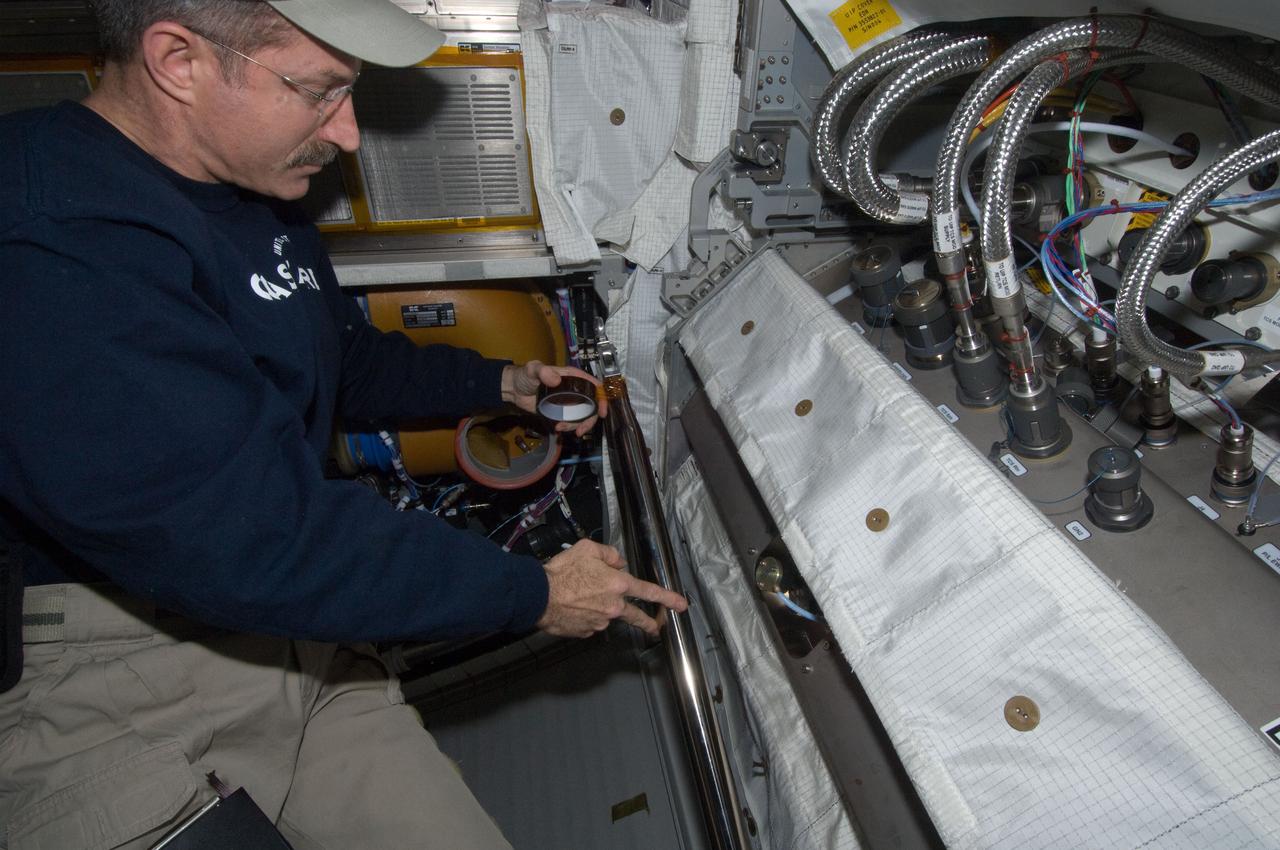 ISS030-E-093414 (22 Feb. 2012) --- NASA astronaut Dan Burbank, Expedition 30 commander, performs the scheduled extensive cleanup of ventilation systems in the Columbus laboratory of the International Space Station.