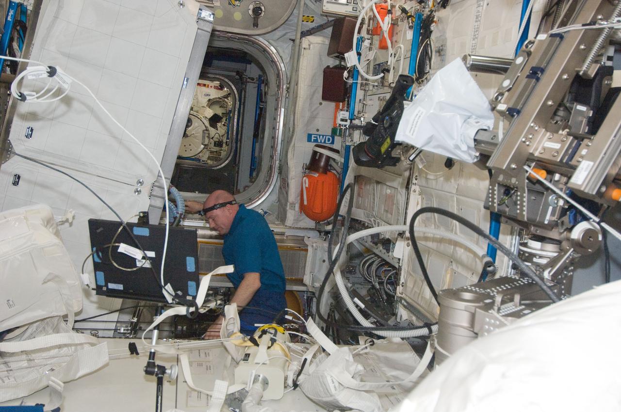 ISS030-E-094534 (23 Feb. 2012) --- European Space Agency astronaut Andre Kuipers, Expedition 30 flight engineer, performs the scheduled inspection and extensive cleanup of ventilation systems in the Columbus laboratory of the International Space Station.