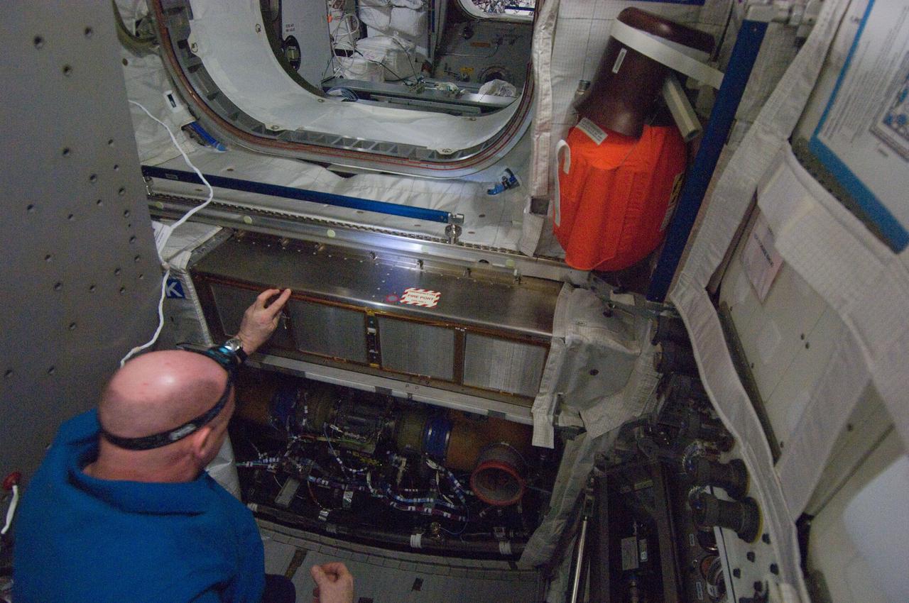 ISS030-E-094598 (23 Feb. 2012) --- European Space Agency astronaut Andre Kuipers, Expedition 30 flight engineer, performs the scheduled inspection and extensive cleanup of ventilation systems in the Columbus laboratory of the International Space Station.