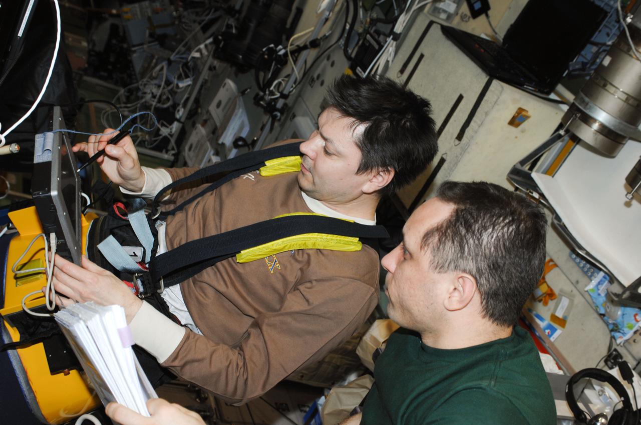 ISS030-E-104844 (28 Feb. 2012) --- In the International Space Station?s Zvezda Service Module, Russian cosmonauts Oleg Kononenko (left) and Anton Shkaplerov, both Expedition 30 flight engineers, work with Russian Lower Body Negative Pressure (LBNP) or Chibis suits (PVK-1, PVK-2), converting them to the advanced version Chibis-M.