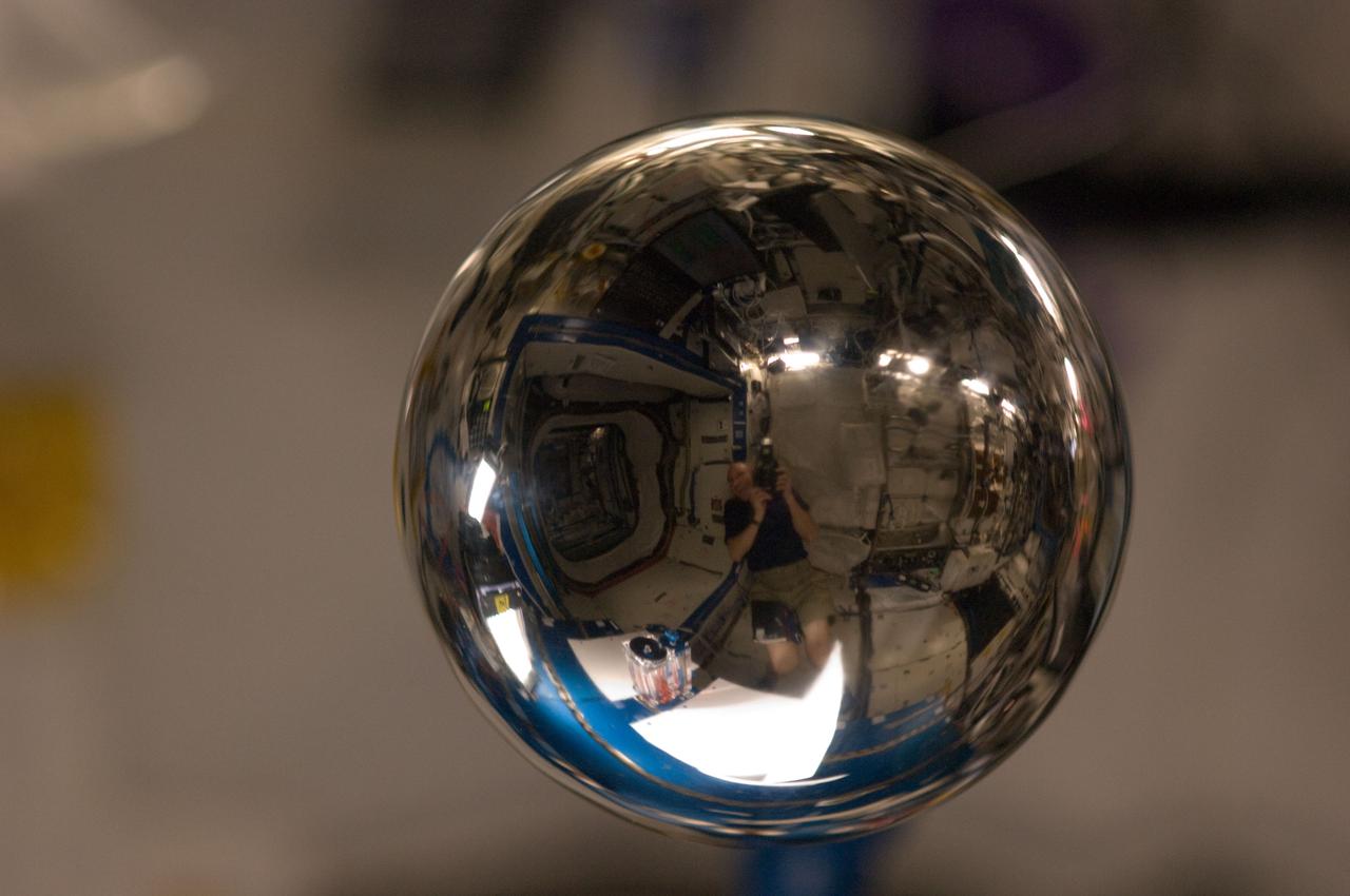 ISS030-E-108804 (28 Feb. 2012) -- A close look at this four-inch polished metal sphere onboard the International Space Station reveals a reflected image of NASA astronaut Don Pettit, Expedition 30 flight engineer. Using a 105-mm lens, Pettit took a series of pictures of the sphere. Also visible is hardware from the Capillary Flow Experiment-2 (CFE-2) Vane Gap 1 Experiment, in the U.S. Laboratory Destiny.