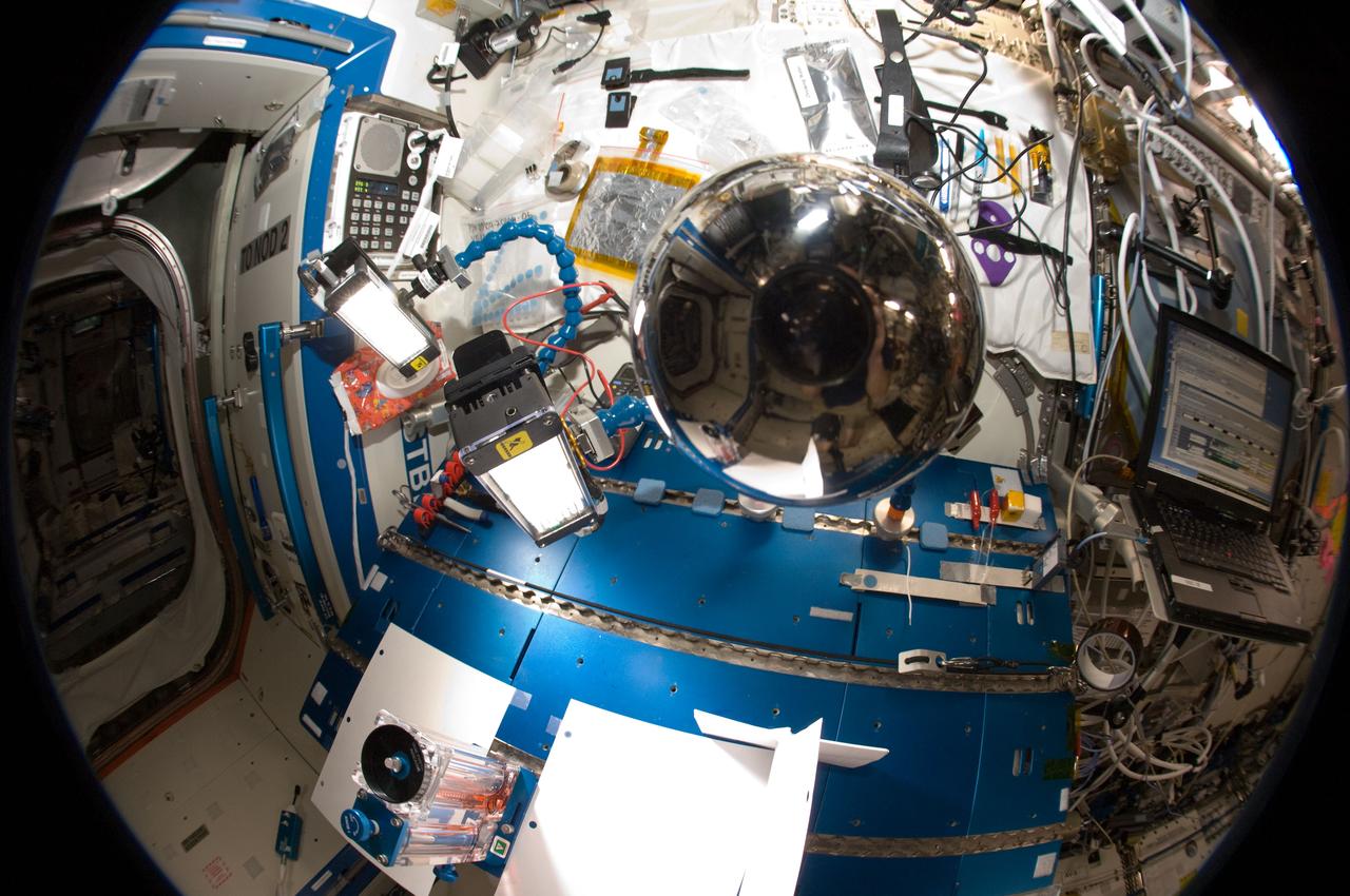 ISS030-E-108820 (28 Feb. 2012) ---  In the center of this "fisheye" lens image is a  four-inch polished metal sphere onboard the International Space Station. Expedition 30 crew members using an 8-mm lens took a series of pictures of the sphere.