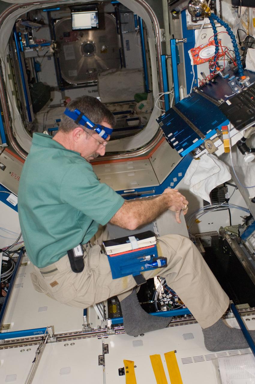 ISS030-E-114433 (29 Feb. 2012) --- In the International Space Station?s Destiny laboratory, NASA astronaut Dan Burbank, Expedition 30 commander, upgrades Multiplexer/Demultiplexer (MDM) computers and Portable Computer System (PCS) laptops and installs the Enhanced Processor & Integrated Communications (EPIC) hardware in the Payload 1 (PL-1) MDM.