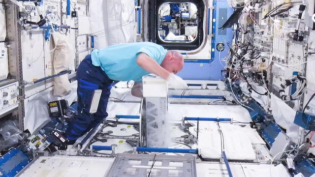 NASA image: Kuipers prepares to insert biological samples in the MELFI